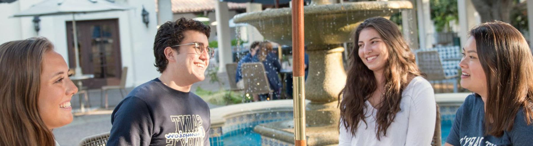 Photo of Saint Mary's peer mentors advising students outside in the sunlight